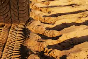 Free photo trace of wheels on a sandy road