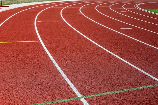 Track running. Red treadmill in sport field. Sports stadium in the open air