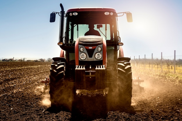 Tractor agricultural machine working in the field