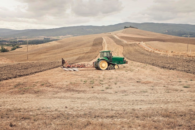 tractor in the countryside, tuscany , italy