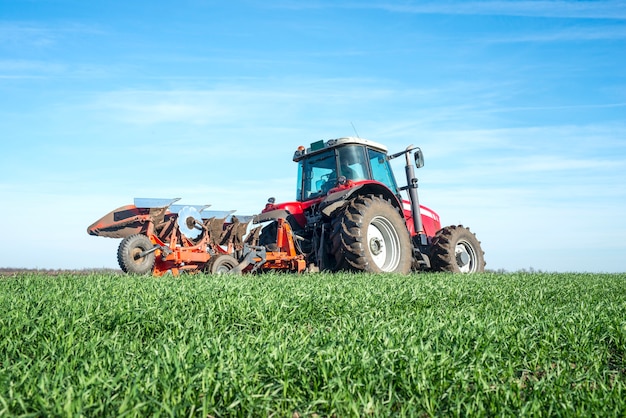 Free photo tractor cultivating field