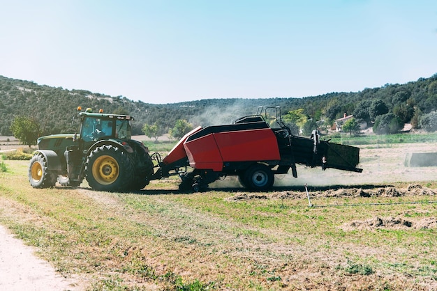 Free photo tractor in the meddle of a cultivation field