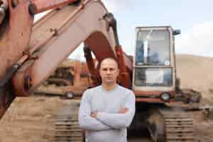 Free photo tractor operator at sand pit