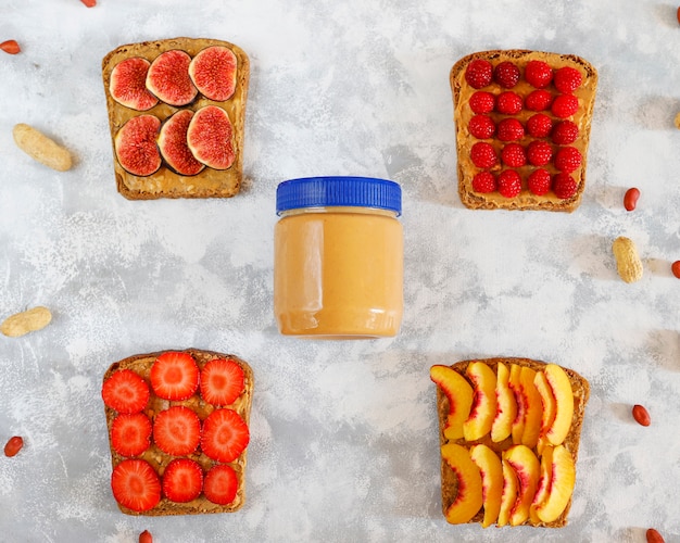 Free photo traditional american and european summer breakfast: sandwiches of toast with peanut butter, copy  top view