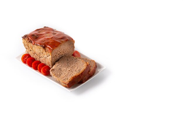 Traditional American meatloaf with ketchup isolated on white background.