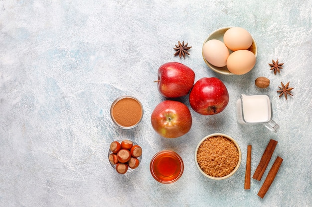 Free photo traditional autumn baking ingredients: apples,cinnamon,nuts.