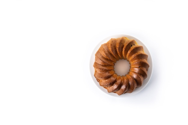 Traditional bundt cake with raisins isolated on white background