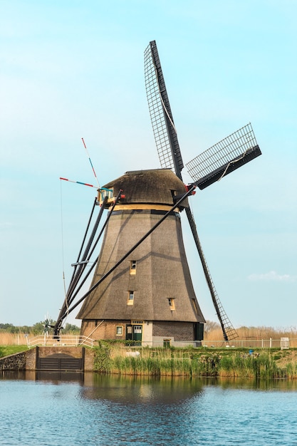 Free photo traditional dutch windmills with green grass in foreground, netherlands