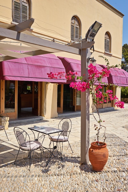 Traditional greek street cafe with flowers