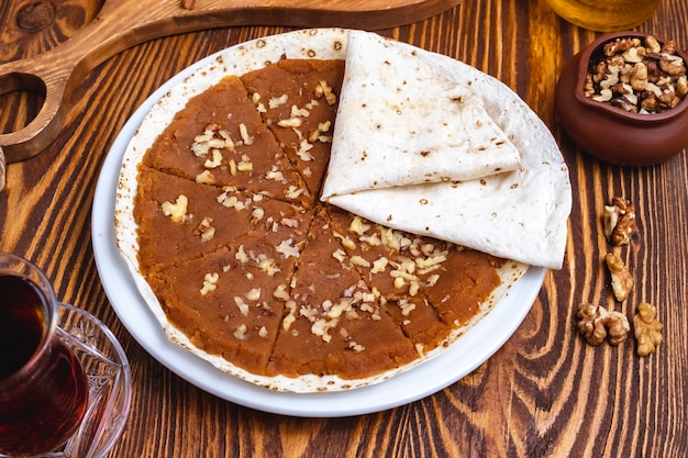 Traditional halva walnuts lavash tea side view