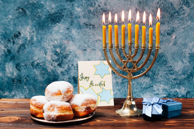 Free Photo traditional hanukkah sweets with candles