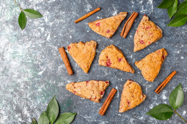 Traditional homemade English scones with frozen raspberries and cinnamon,top view