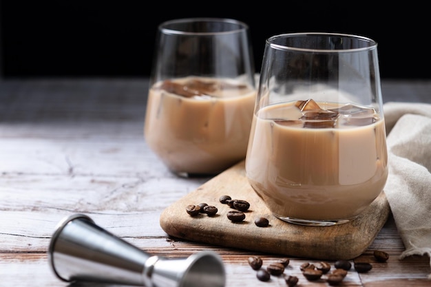 Free Photo traditional irish cream coffee liqueur with ice on wooden table