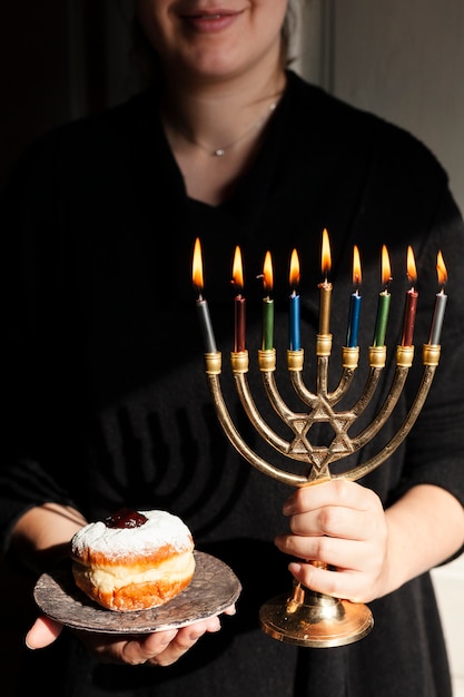 Free photo traditional jewish menorah and a donut