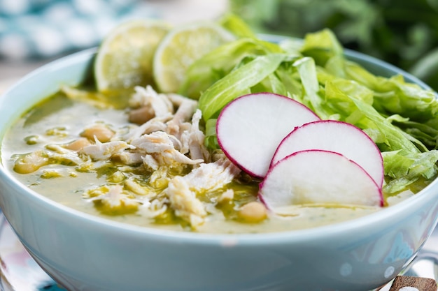 Free photo traditional mexican green pozole soup on wooden table