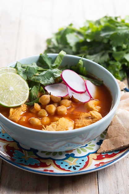 Free Photo traditional mexican red pozole soup on wooden table