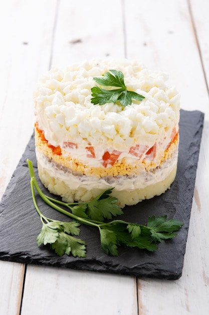 Traditional Russian layered salad Mimosa