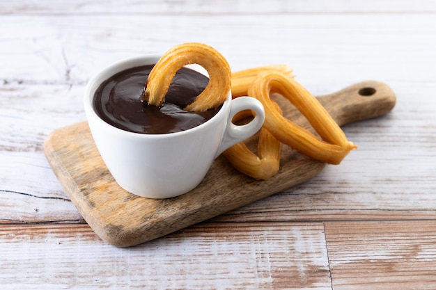 Free photo traditional spanish churros with hot chocolate breakfast on wooden table