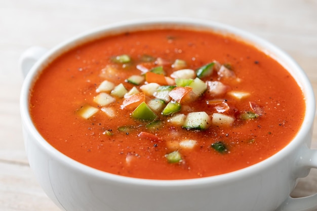 Traditional Spanish gazpacho soup in bowl on wooden tablexA