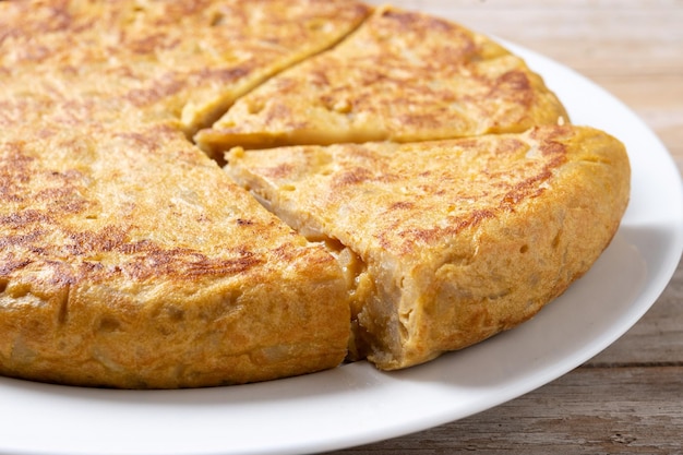 Free Photo traditional spanish omelette with ingredients on wooden tablexa