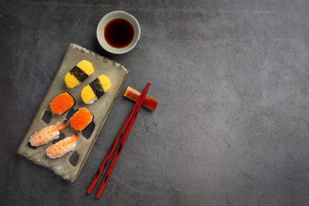 Traditional sushi on dark surface