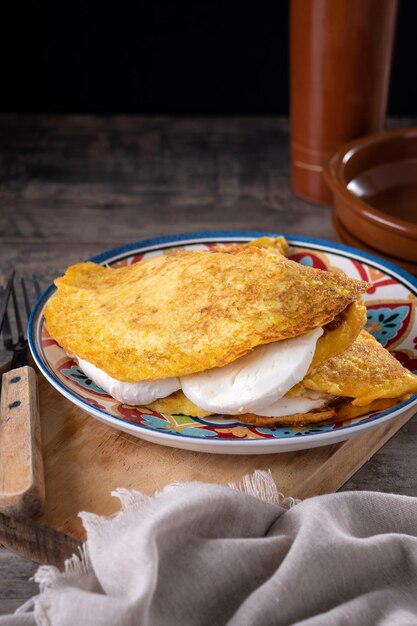 Traditional Venezuelan beef cachapa on wooden table