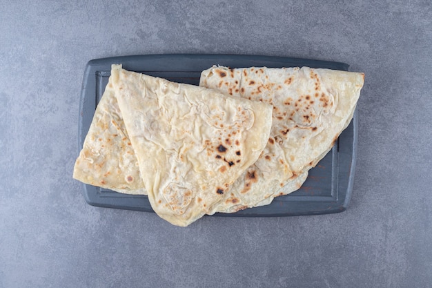 Free Photo traditional wheat lavash bread on the wooden tray , on the marble.