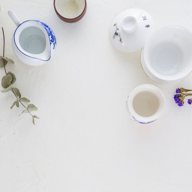 Traditional white and blue coffee cup and teapot on white background