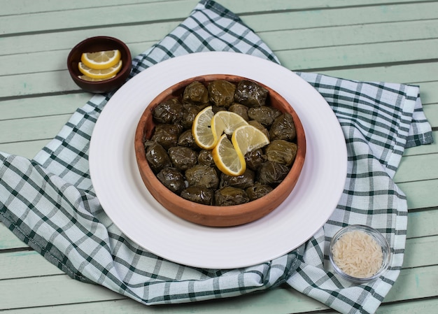 Free Photo traditional yarpag dolmasi with lemon slices in the white plate.