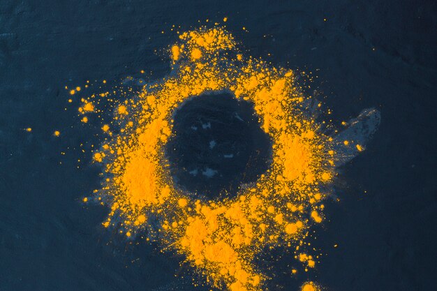 Traditional yellow festive powder on colored textured background