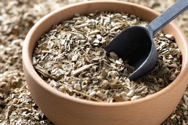 Free photo traditional yerba mate in wooden bowl on wooden table