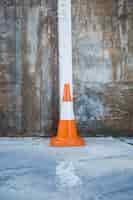 Free photo traffic cone against wall