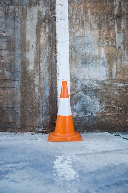 Free Photo traffic cone against wall