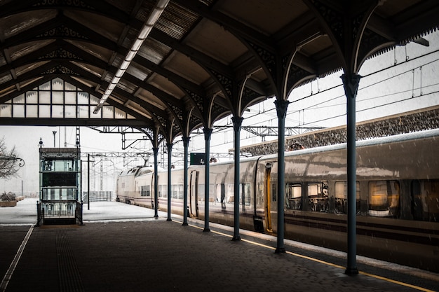 Train in a railway station covered with snow in winter