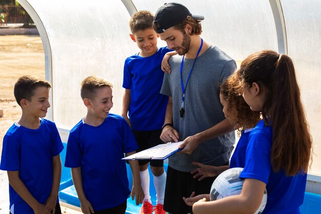 Trainer talking to players side view