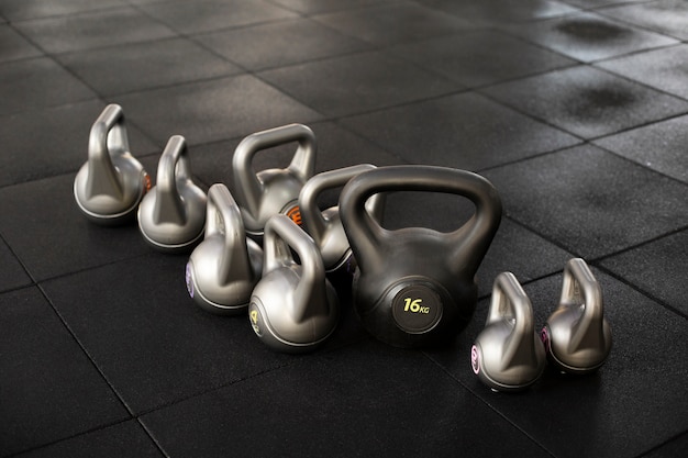 Free photo training at gym concept with kettlebells high angle