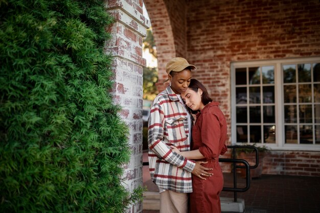 Trans couple hugging and being affectionate on the city streets