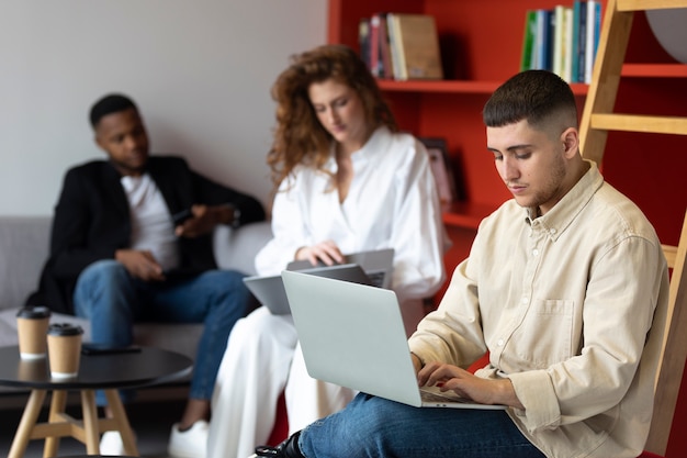 Trans man at work with laptop