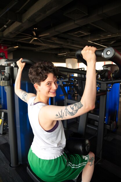 Trans man working out and exercising at the gym