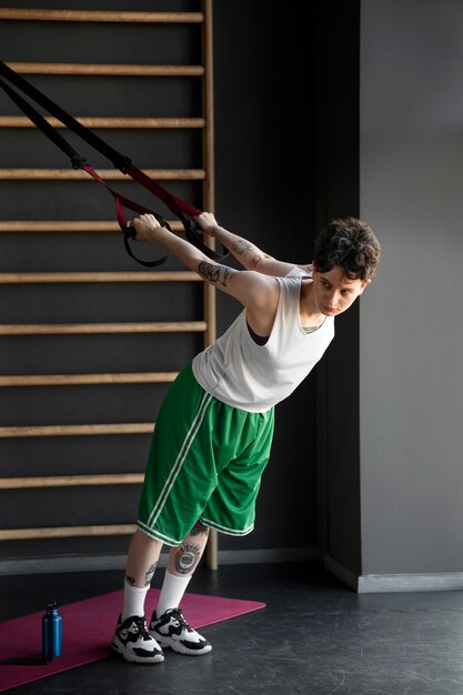 Trans man working out and exercising at the gym