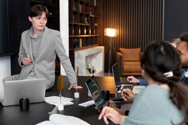 Trans person working at office with colleagues