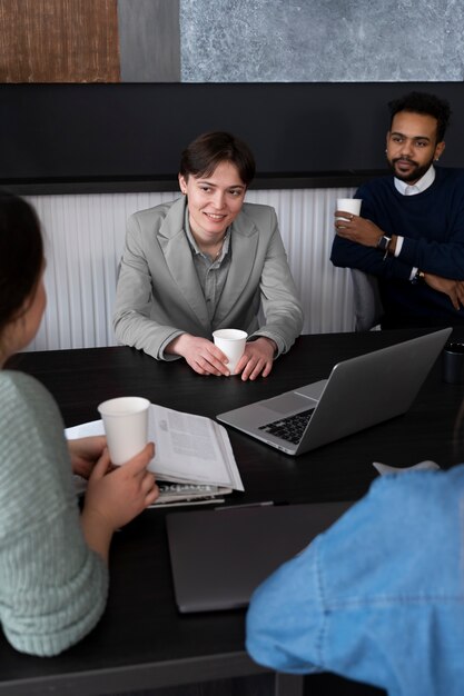 Trans person working at office with colleagues