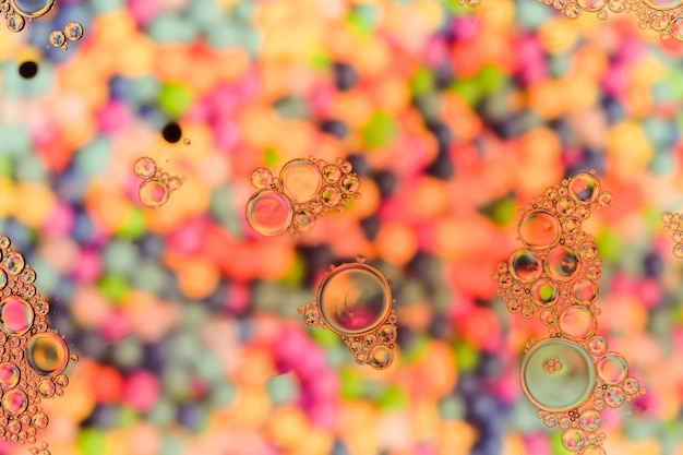 Free photo transparent bubbles on warm pearl colour surface