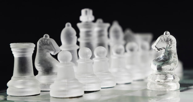 Free photo transparent chess pieces on board