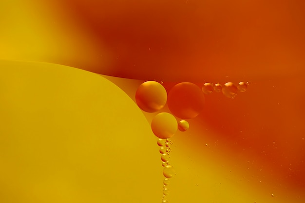 Free photo transparent droplets on watery orange backdrop