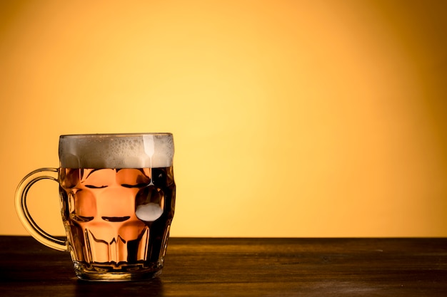 Transparent glass of beer wooden table 