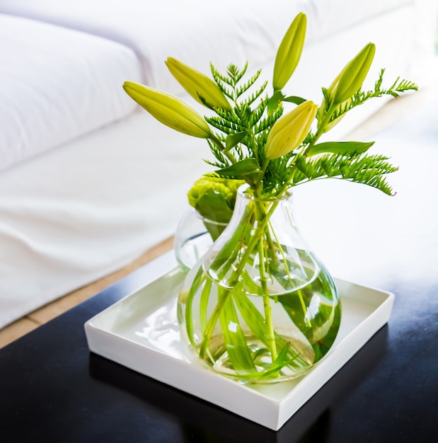 Free photo transparent glass with green flowers on it placed as an interior decor in a house