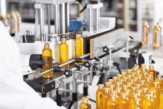 Free photo transparent plastic bottles filled with yellow substance