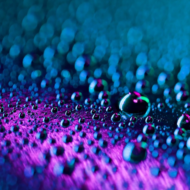 Free photo transparent water droplets macro on dark and bright background