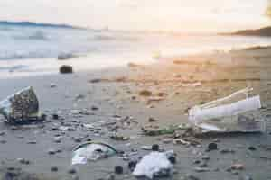 Free photo trash on sand beach showing environmental pollution problem